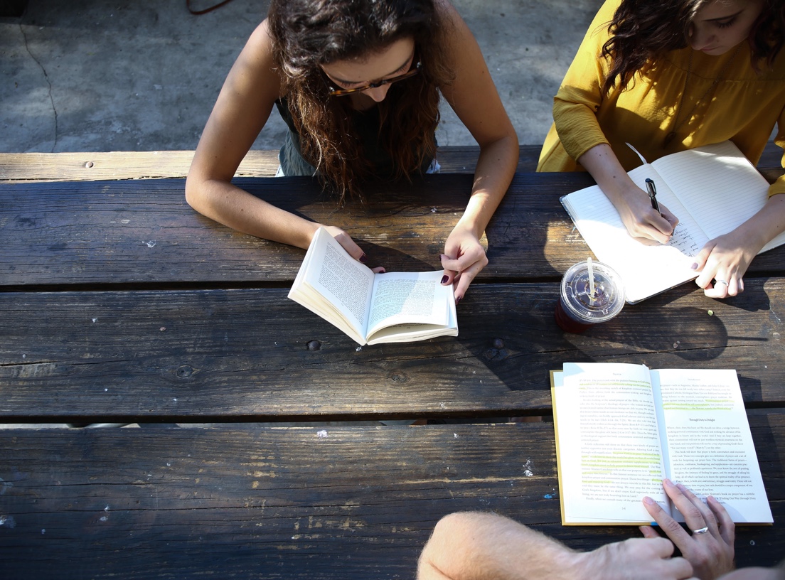 photo of students studying around the table.