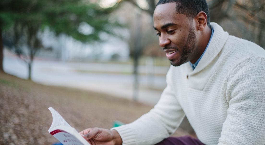 picture of man reading a book.