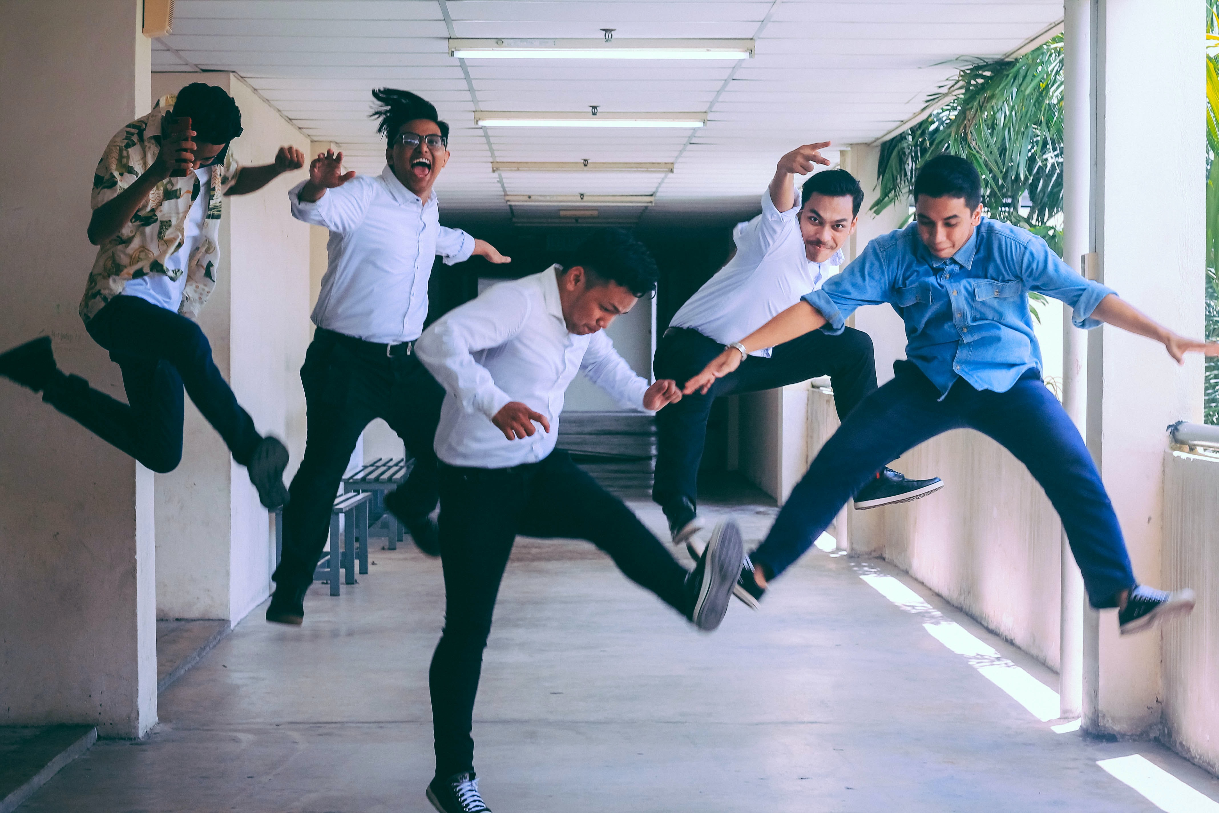 Group of friends jumping for a photo.